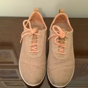 Tom’s orange tennis shoes